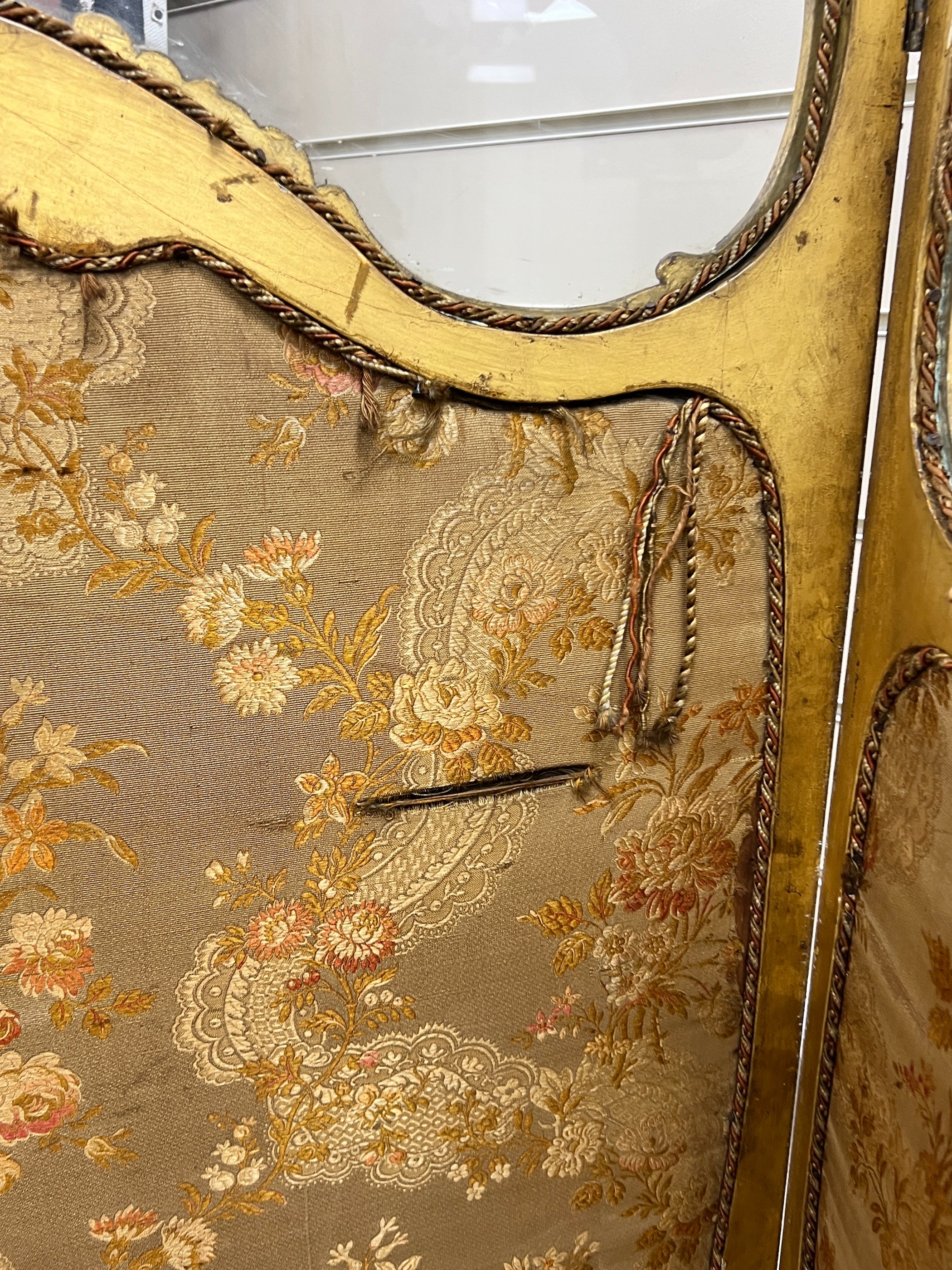 A Louis XV style carved glazed giltwood three fold dressing screen, height 185cm